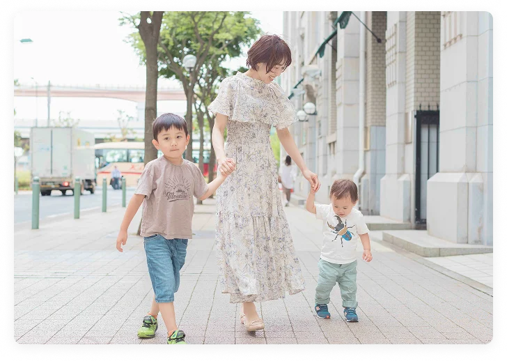 笑顔で手を繋ぐ母子の写真